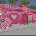 Pink Heart Shaped Outdoor Booth Decorated With Flowers Heart Cup Sign And Green Plants
