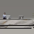 Modern Reception Desk With Marble Countertop Two Computer Monitors Potted Plant And Professional Staff Member