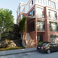 Detached Villa With Red Brick Exterior Large Glass Windows Vines Stone Steps And Rock Features