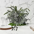 Elegant Tableware Set with Marble Tabletop Greenery Arrangement Wine Glasses Ceramic Plates and Metal Cutlery