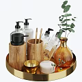 Stylish Bathroom Accessories on Gold Tray with Wooden Holders Black Pump Bottles and Green Plant