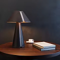 Modern Table Lamp Featuring Dark Leather Shade On Wooden Table With Coffee Cup And Books
