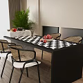 Modern Dining Table Set with Black White Checkered Top Rattan Chairs and Green Plant