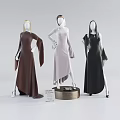 Fashion Mannequins Wearing Brown Beige Black Long Dresses With Unique Cuts And Poses On Stand