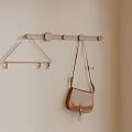 Wooden Hook Rack With Metal Hooks And Brown Bag Hanging On Wall