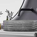 Diamond Textured Glass Washbasin With Black Faucet Green Plants Yellow Bottle And Round Mirror