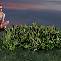 Lush Green Plants in Front of Sunset Sky with Girl Sitting by Water Surface
