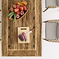 Rustic Long Wooden Table and Woven Chair Set with Fruits and Bread