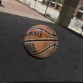 Spalding NBA Official Basketball With Brown Leather Surface And Black Stripes On Outdoor Brick Pavement