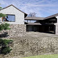 Traditional Homestay Building Exterior with Stone Wall Tile Roof Windows and Courtyard Entrance