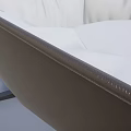 Modern Leisure Chair With Beige Leather Upholstery Curved Backrest And Swivel Base