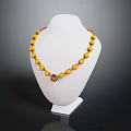 Yellow Beaded Necklace With Red Accent Beads And Pendant On Mannequin