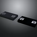 Vintage Electronic Storage Devices With Two Black VHS Tapes