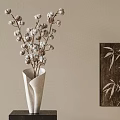 White Vase With Cotton Branches On Dark Wooden Base And Bamboo Leaf Wall Art