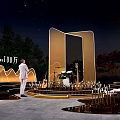 Night Outdoor Event Scene With Golden Curved Stage Musical Instruments And Seating Area