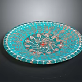 Turquoise Hand Carved Plate With Intricate Swirls Floral Patterns And Central Red Accent
