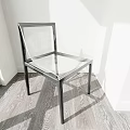 Modern Transparent Single Chair With Metal Frame In Minimalist Interior Space