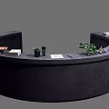 Curved Dark Reception Desk With Green Plant Books And Decorative Items