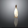 Penguin Figurine With Brown Head White Body And Yellow Feet Standing On Dark Background