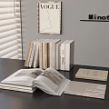 Stylish Books And Vogue Magazine Display With MinotLi Sign Open Book On Table
