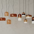 Multiple Pendant Lights With Various Colors And Shapes Hanging Against Light Colored Wall 3d model