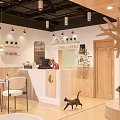 Modern Cozy Dessert Shop Interior With Wooden Counter Golden Pendant Lights And Decorative Plants