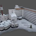 Aerial View of Snow Covered Building Complex with Tower and Parking Lot