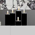 Decorative Ornament Set With Lit Candles Stacked Books And Marble Wall Backdrop On White Cabinet
