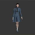 Woman Wearing Blue Dress with Braid and Blue Shoes Standing Against Gray Background