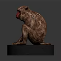Detailed Monkey Sculpture Sitting On Black Base With Red Face And Brown Fur