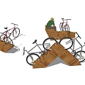 Triangular Wooden Bike Racks With Bicycles And Person Sitting Nearby