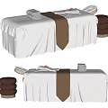 Elegant Massage Bed Setup With White Sheets Brown Towel And Stacked Towels