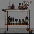 Golden Bar Cart With Glass Top Holding Bottles Glasses And Flower Vase
