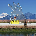 Rural Landscape With Giant White Palm Sculpture Wooden Platform Mountain Blue Sky And Waterfront Reeds