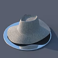Woven Wide Brim Hat Placed On A Silver Round Plate Surface