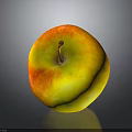 Red And Yellow Apple With Stem On Dark Reflective Surface