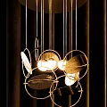 Modern Metal Geometric Chandelier with Circular Framework and Warm Glowing Light