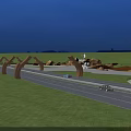 Curved Arch Shaped Landscape Sculptures Along Highway Illuminated At Night With Cars Driving