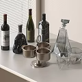 Wine Bottles and Glasses Display on White Countertop with Wine Liquor Bottles Metal Glass Cups