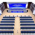 Spacious Conference Hall With Rows Of Seats Stage Blue Screens And Banners