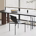 Modern Black Table and Chair Set with Books on Table Near Window Blinds and Plant