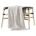 Wooden Stool With Black Seat And Beige Fringed Blanket Draped Over