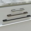 Modern Cabinet Handles In Various Colors Installed On Gray Cabinet Doors
