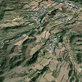 Aerial View Of Rural Mountainous Landscape With River Road And Farmland