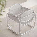 Modern White Stool With Metal Frame And Mesh Design On Wooden Floor And Green Plant