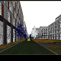 Modern Office Buildings In Urban Setting With Greenery Sculpture And Pedestrians