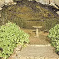 Natural Cave Landscape With Lush Green Plants Stone Pathway And Round Stone Table