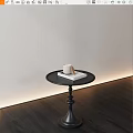 Black Round Side Table With White Cup And Book On Dark Wooden Floor Light Wall