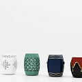 Various Decorative Stools Featuring Intricate Cutouts Geometric Patterns Gold Trims And Tassel Details