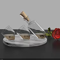 Elegant Transparent Glasses With Liquid Near Bottle And Red Rose On Marble Base